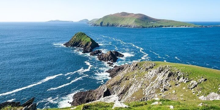 Scenic view of a mountain surrounded by water  